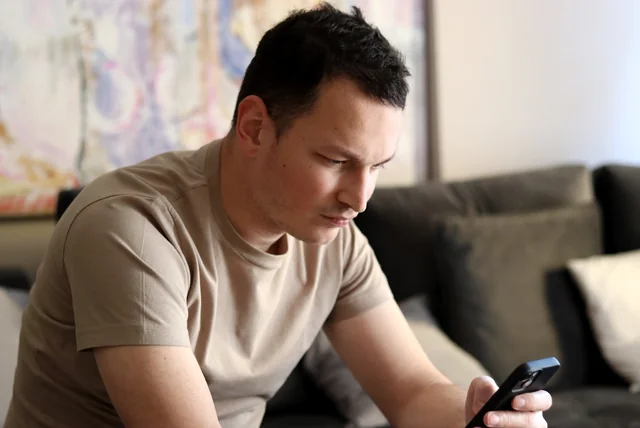 man realising an online advert was a bank transfer scam