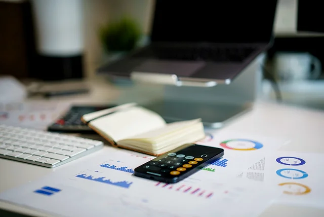 desk with charts and a calculator showing why credit scores differ between agencies