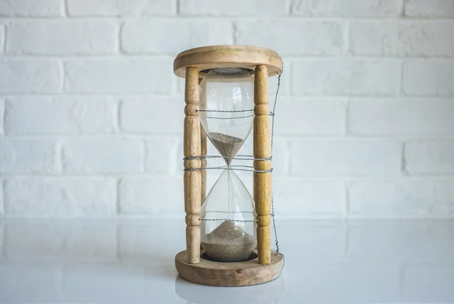 Hourglass on a table showing time passing until penalty points are removed