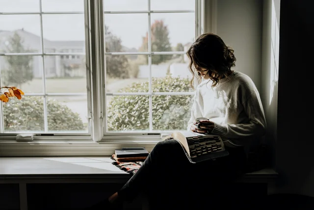 Person reading paperwork at home before checking their driving licence points