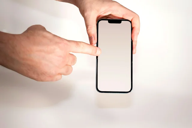 a thumb about to tap a link in a text message on a smartphone