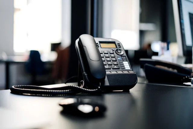 Desk phone in an empty office, the missing contact details behind fake online shops