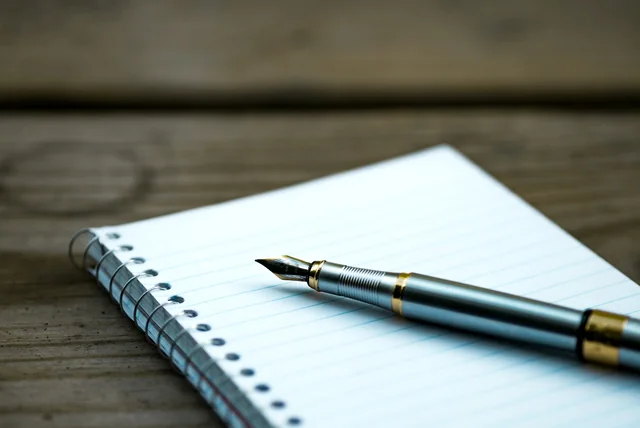 fountain pen on a notebook for drafting a password notice of correction