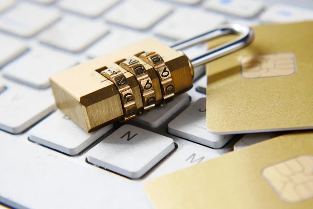 freeze credit file uk – padlock and bank cards resting on a computer keyboard