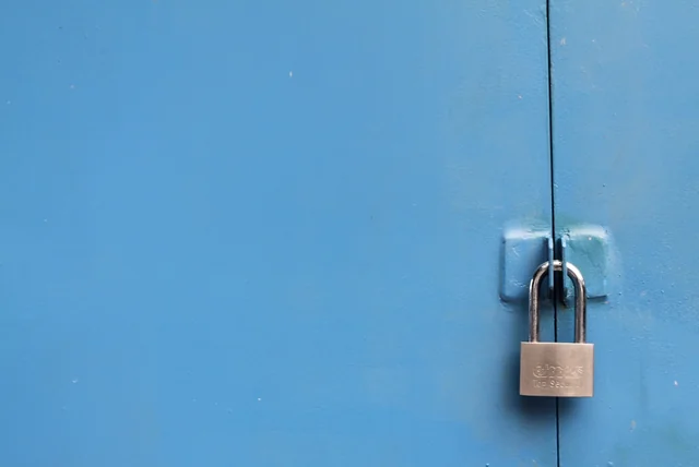padlock on a blue door representing locking down accounts after bank details were stolen
