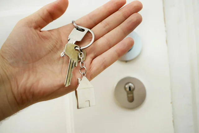 A key held in front of a door lock, like NHS login opening the NHS App