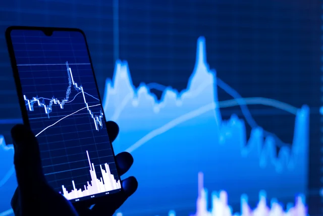 a trading chart on a phone screen like the fake dashboards investment scammers use