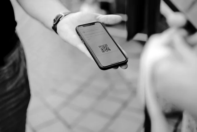 a QR code on a phone screen, the quishing trick used in scam emails