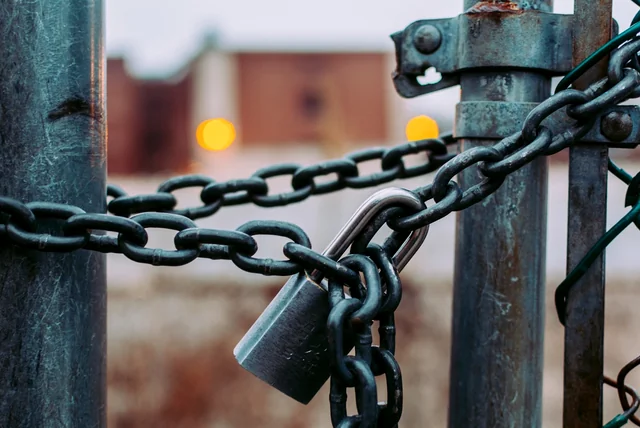 a padlock and chain showing what scam website takedowns can and cannot do