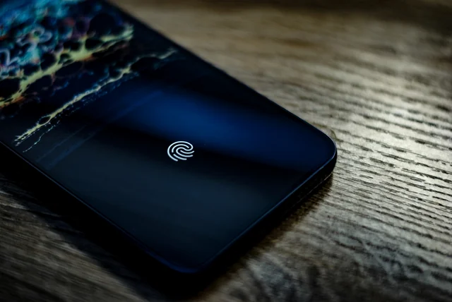 Smartphone showing a fingerprint icon used by certified identity check providers
